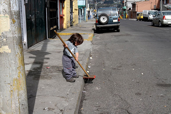 child sweeping sidewalk