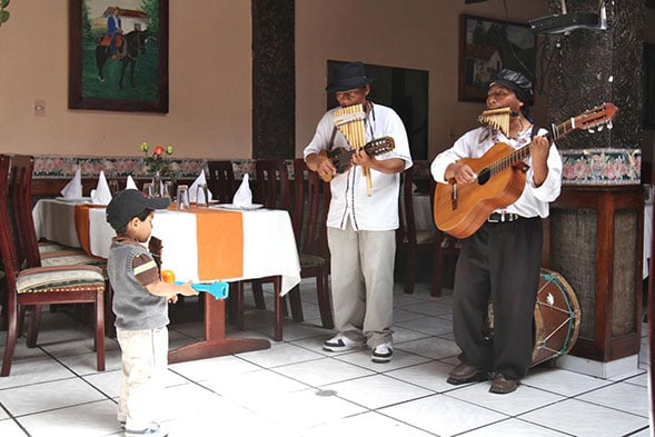 mariachi band performing with a young boy
