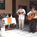 mariachi band performing with a young boy