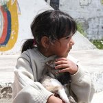 young girl holding a puppy