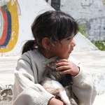 young girl holding a puppy
