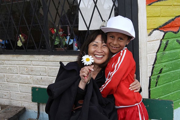 older lady with young boy and a daisy