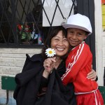 older lady with young boy and a daisy