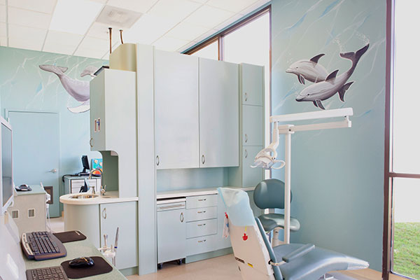 blue dental suite with mural of dolphins