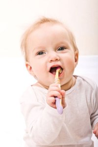 baby with toothbrush