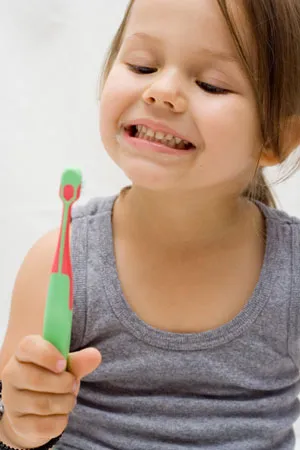 kid holding toothbrush