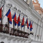 Flags in front of a building balcony