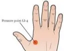 Hand illustration showing pressure point LI-4 — located in the web between thumb and index finger, marked with an orange circle and labeled “Pressure point LI-4.”